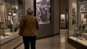 Visitor viewing a Holocaust museum exhibition