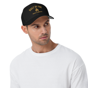 Man wearing a black baseball cap with 'BUILT BY FIRE', 'BRASS & BUNKER CO'